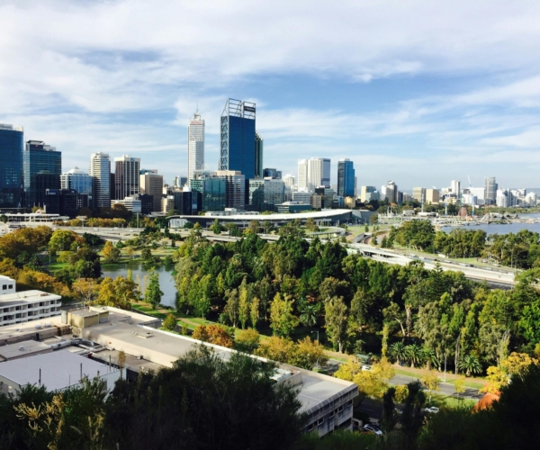 A picturesque view of Perth city skyline and Kings Park during a bright day.